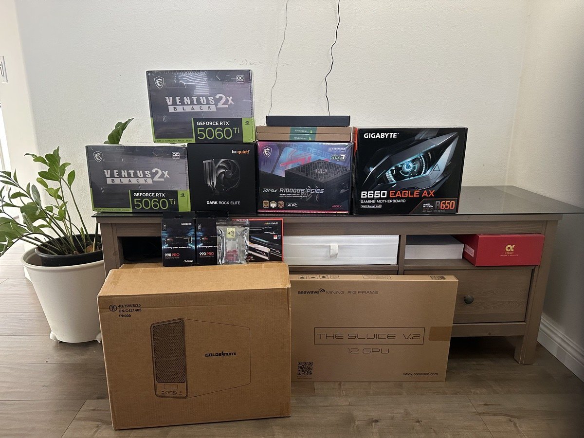 Component boxes stacked before assembly: two MSI RTX 5060 Ti cards, a be quiet! CPU cooler, a 1000W MSI PSU, a GIGABYTE B650 motherboard, two Samsung 990 Pro NVMe drives, DDR5 memory, and the boxed open-frame mining chassis.